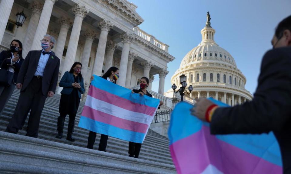 Deb Haaland holds a Transgender Pride flag beside democratic colleagues on Capitol Hill in Washington, 25 February 2021.