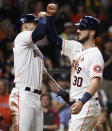 Houston Astros' Kyle Tucker (30) celebrates his two-run home run with Carlos Correa during the seventh inning of a baseball game against the Texas Rangers, Saturday, May 15, 2021, in Houston. (AP Photo/Eric Christian Smith)