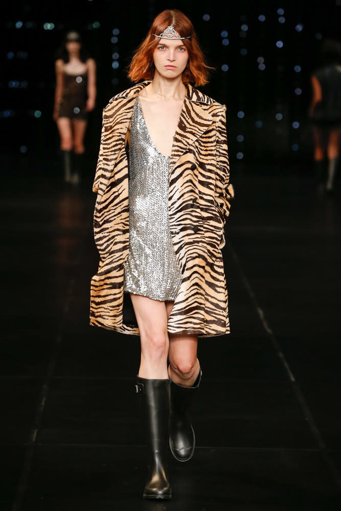A shimmering dress under a tiger print coat at Saint Laurent SS16.