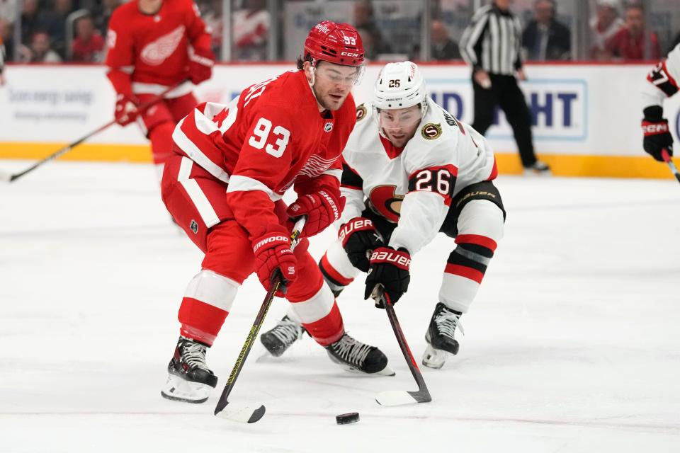 Detroit Red Wings right wing Alex DeBrincat (93) moves to shoot as Ottawa Senators' Erik Brannstrom (26) defends in the first period at Little Caesars Arena on Saturday, Dec. 9, 2023.