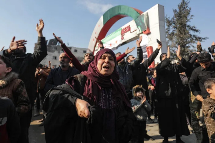 Demonstrators raise Syrian opposition flags and signs in a rally against talks in Moscow between Turkey and Assad’s regime in Syria (AFP via Getty)