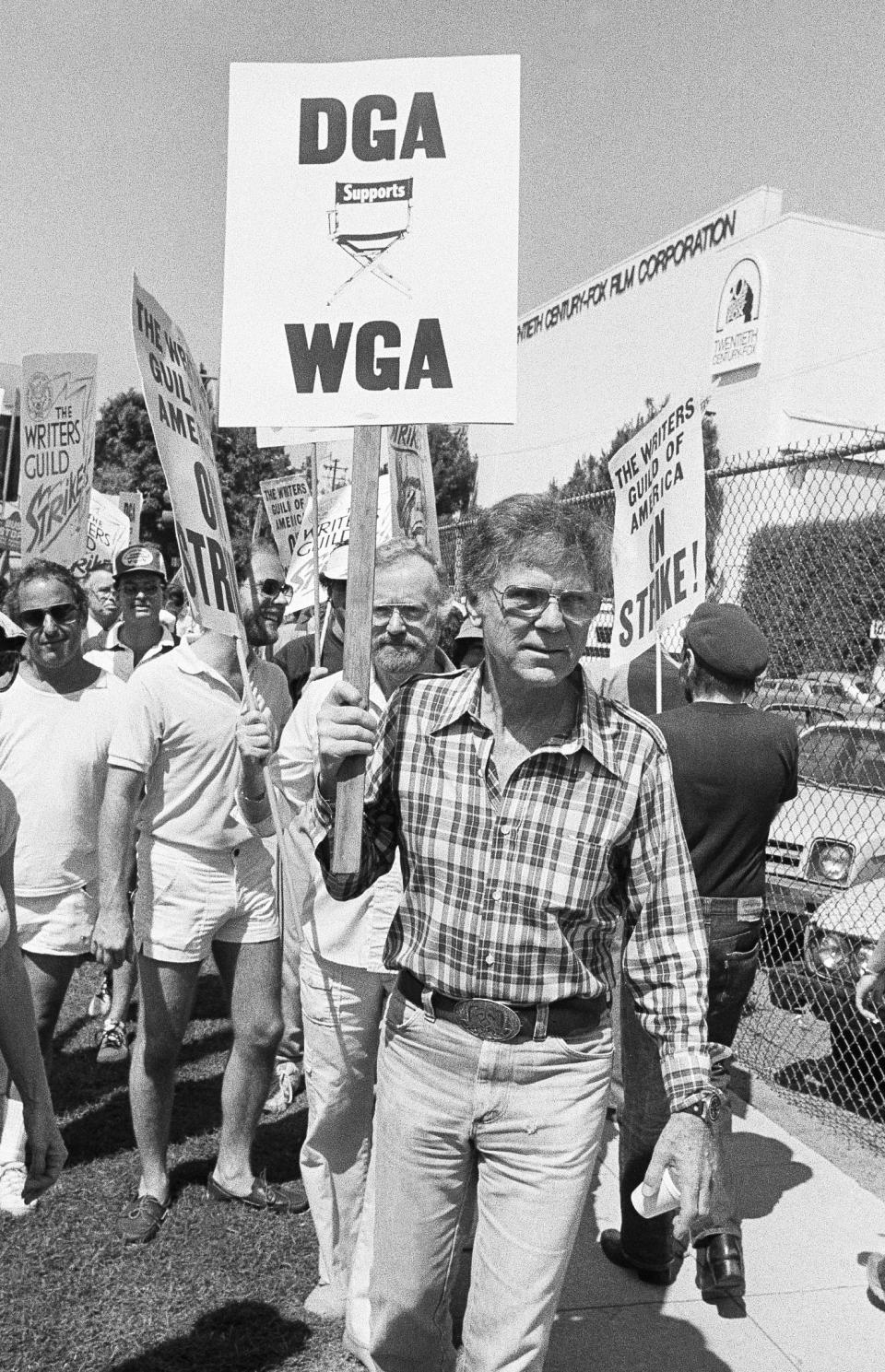 FILE - Actor-director Jackie Cooper joins members of the striking Screen Writers and Directors Guilds during a massive picket of the 20th-Century Fox studio in Los Angeles on June 25, 1981. Members of the Screen Writer's Guild have been on strike for 11 weeks after talks with producers reached an impasse over the pay-TV issue. (AP Photo/Wally Fong, File)