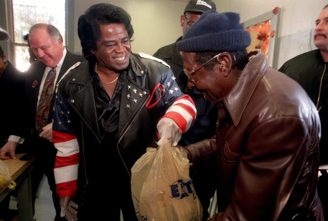 James Brown passes out turkeys at his fifth annual Turkey Giveaway at Dyess Park, in this photo from November 1997. The giveaway continued through the James Brown Family Foundation after the legendary singer's death in 2006.