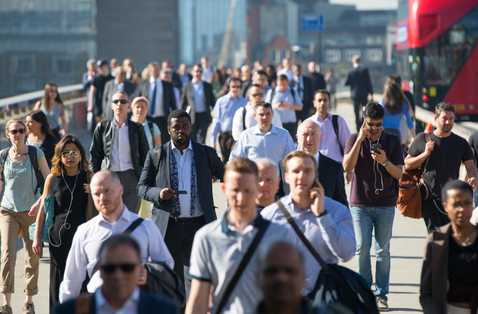 London, UK. Blurred image of office workers crossing the London bridge in early morning on the way to the City of London. Rush hours