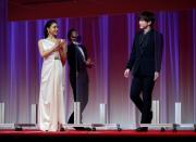 Cast members Tao Tsuchiya and EXILE Naoto from the movie 'Food Luck' enter between plastic walls installed in order to prevent infections following the coronavirus disease (COVID-19) outbreak, at the 33rd Tokyo International Film Festival in Tokyo