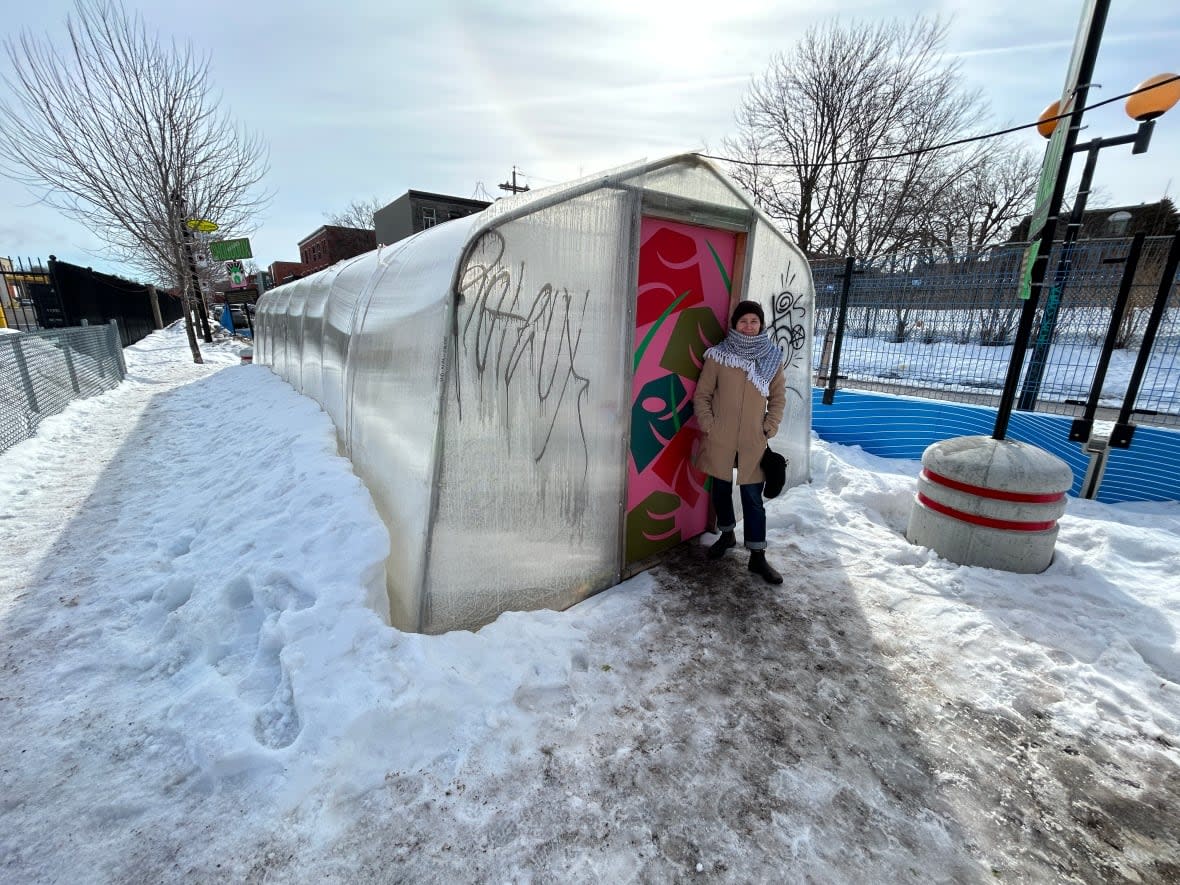 Beccah Frasier, executive co-director at the Carrefour Solidaire Centre Communautaire d'Alimentation, stands in front of a customized carport that has a secret inside. (Fenn Mayes/CBC - image credit)