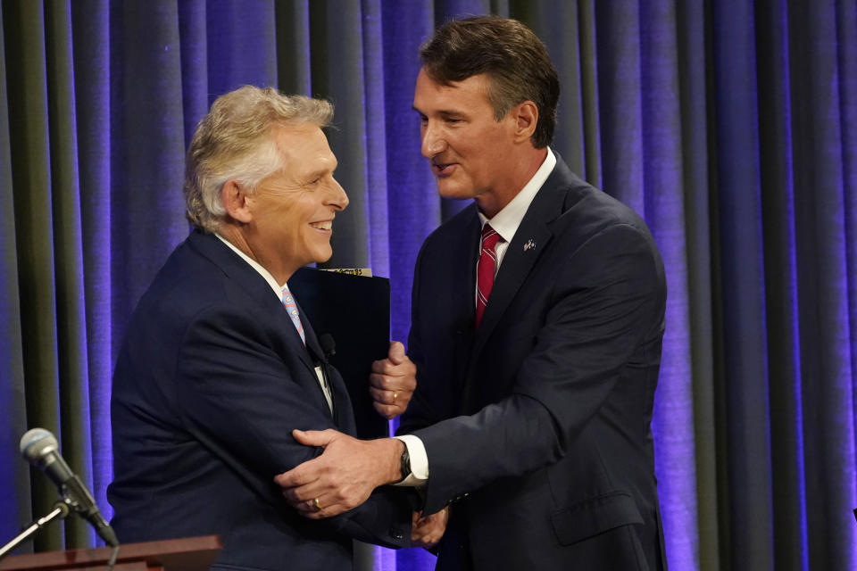 Democratic gubernatorial candidate and former governor Terry McAuliffe, left, greets his Republican challenger, Glenn Youngkin, after a debate at the Appalachian School of Law in Grundy, Va., Thursday, Sept. 16, 2021. (AP Photo/Steve Helber)