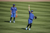 Chicago Cubs center fielder Ian Happ, right, throws the ball during baseball practice as left fielder Kyle Schwarber, left, looks on at Wrigley Field on Friday, July 3, 2020 in Chicago. (AP Photo/Kamil Krzaczynski)