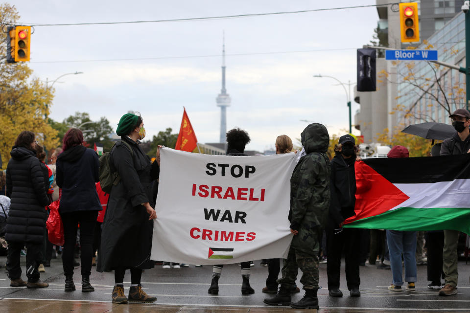 People gather outside the constituency office of Canada's Deputy Prime Minister Chrystia Freeland during a rally in support of Palestinians on Oct. 20 in Toronto. (Photo by Mert Alper Dervis/Anadolu via Getty Images)