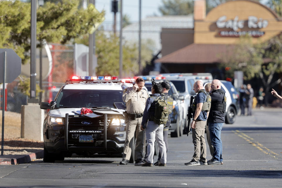 Law enforcement officers gather near Greenspun Hall on the University of Nevada, Las Vegas, campus after reports of an active shooter, Wednesday, Dec. 6, 2023, in Las Vegas. (Steve Marcus/Las Vegas Sun via AP)