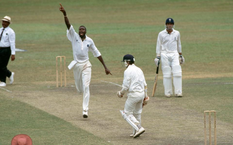 West Indies fast bowler Curtly Ambrose celebrates the wicket of England batsman Jack Russell, caught by Carl Hooper (bottom left) for 4 runs, during the 3rd Test match between West Indies and England at Queen's Park Oval, Porthna Spain, Trinidad, 17 February 1998. Mark Butcher is the unbeaten batsman for England and Eddie Nicholls is the umpire.  England won the match by 3 wickets