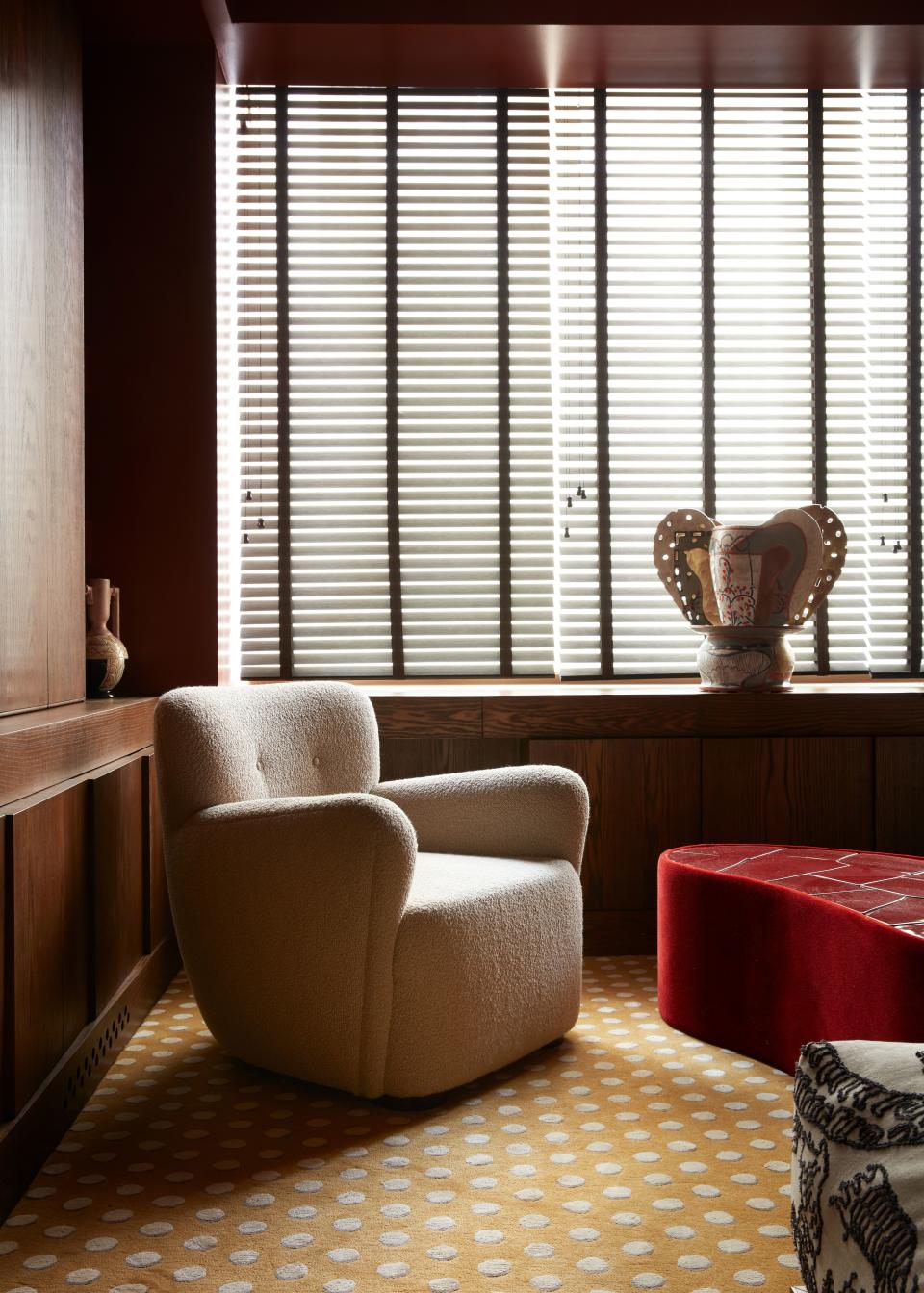 Valle jokingly refers to this cozy room, the most colorful and most decorated space in the apartment, as a “smoking den.” The silk-and-wool yellow rug is from Pierre Frey, and the off-white club chair is by Studio Giancarlo Valle.