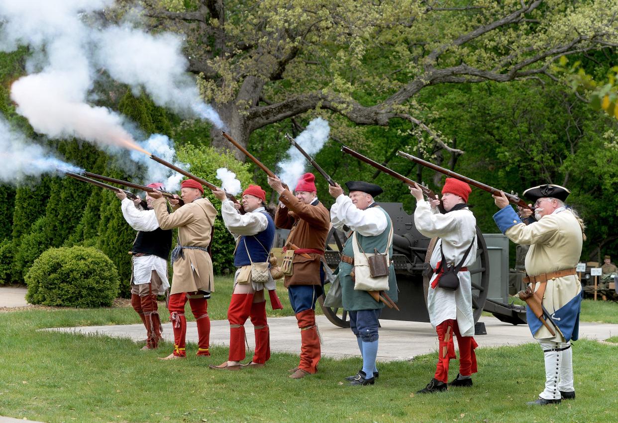 Reenactors wearing outfits from the mid 18th century fire their flintlocks during a demonstration at the Illinois State Military Museum Saturday, May 6, 2023, as part of the commemoration of the Illinois National Guard's 300 anniversary. 