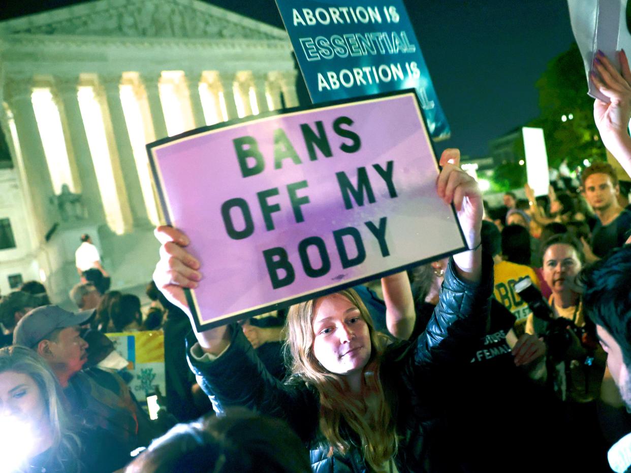 Pro-abortion-rights protester holds poster that reads,"Bans off my body."