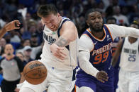 Dallas Mavericks guard Luka Doncic, left, and Phoenix Suns forward Jae Crowder (99) battle for a loose ball during the second half of Game 3 of an NBA basketball second-round playoff series, Friday, May 6, 2022, in Dallas. (AP Photo/Tony Gutierrez)