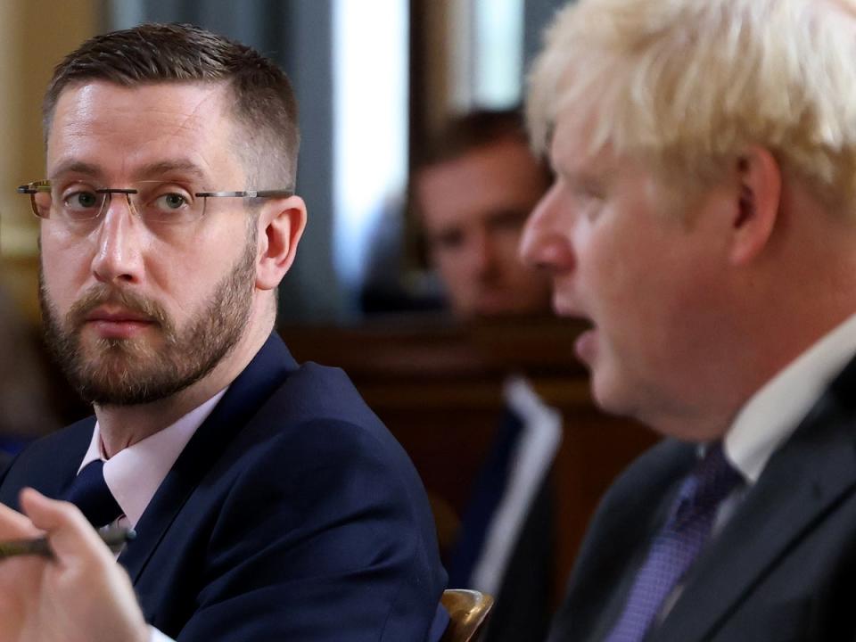 Boris Johnson pictured with Simon Case, who reportedly gave advice to the former PM to stop seeking financial advice from Richard Sharp  (Downing Street)