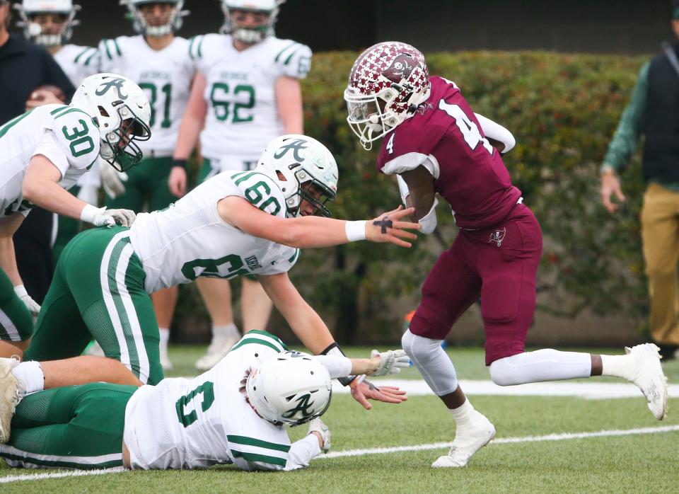 Caravel's Vandrick Hamlin (right) gains ground on a kick return in the first quarter of the DIAA Class 2A championship at Delaware Stadium, Saturday, Dec. 2, 2023.