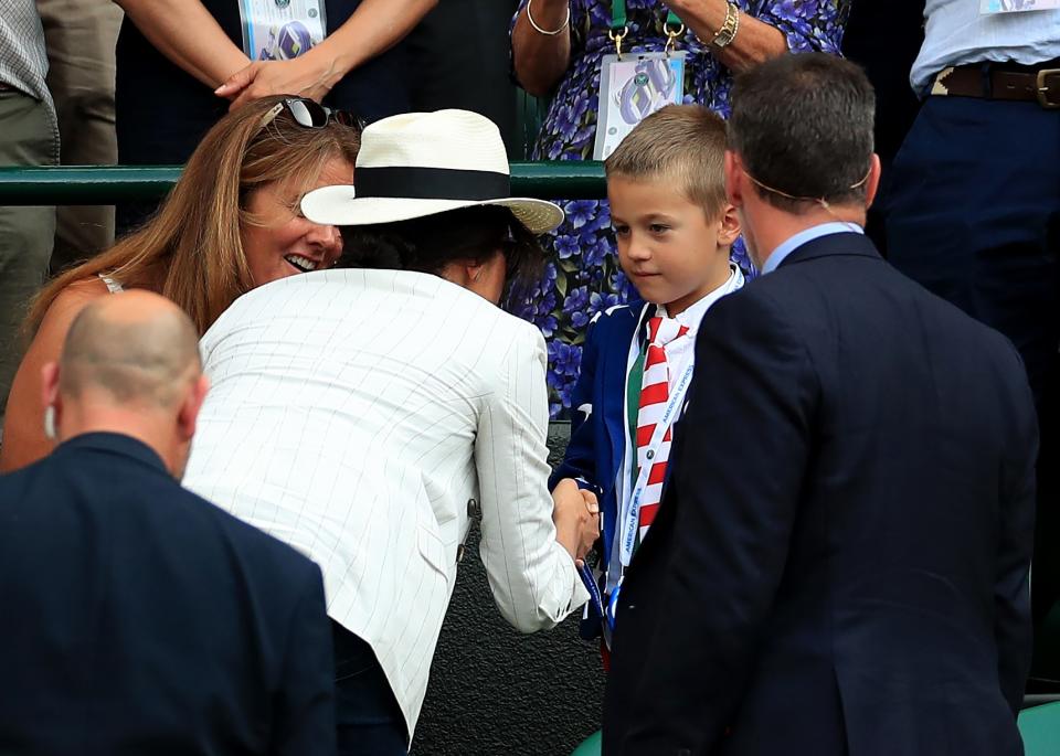 Meghan Markle chatting with a young fan at Wimbledon