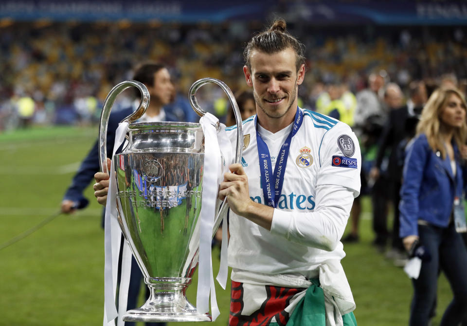 FILE - Real Madrid's Gareth Bale celebrates with the trophy after winning the Champions League Final soccer match between Real Madrid and Liverpool at the Olimpiyskiy Stadium in Kiev, Ukraine, Saturday, May 26, 2018. (AP Photo/Pavel Golovkin, File)
