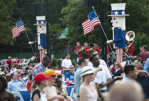 Guests attend an Independence Day celebration for members of the military and their families hosted by US President Barack Obama on the South Lawn of the White House in Washington, DC, July 4, 2012