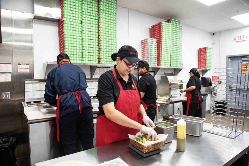 Jasbir Kaur prepares pasta dish at Pizza Twist in Modesto, Calif., Thursday, April 6, 2023.