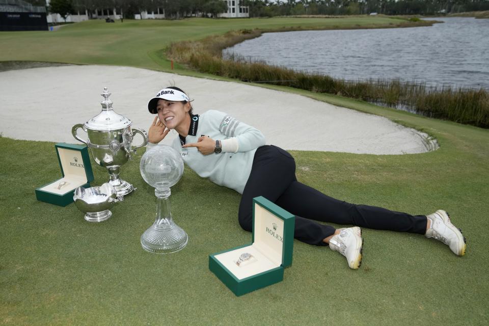 Lydia Ko, of New Zealand, poses with the Rolex Player of the Year trophy, left, the Vare trophy, center, and the LPGA CME Group Tour Championship trophy, right, after the final round of the LPGA CME Group Tour Championship golf tournament, Sunday, Nov. 20, 2022, at the TiburÃ³n Golf Club in Naples, Fla. (AP Photo/Lynne Sladky)