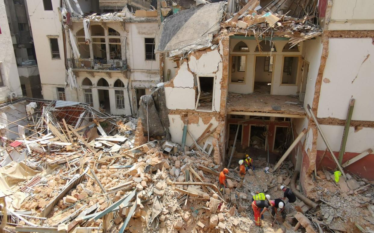 Rescue workers at the site of the collapsed building - NABIL MOUNZER/EPA-EFE/Shutterstock