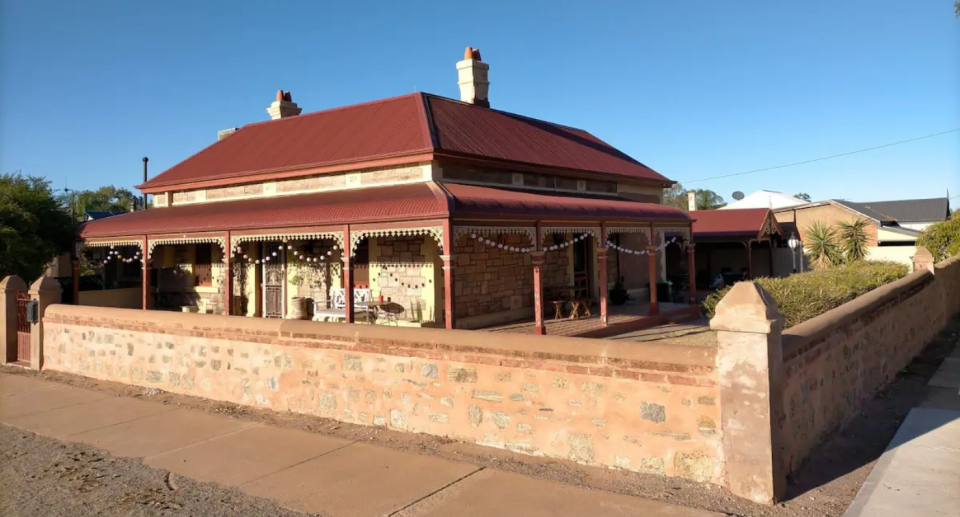 McQueen House, one of Broken Hill's grand old stone houses, offers four bedrooms: one with two single beds, two with queen beds and one with a double. Photo: Airbnb