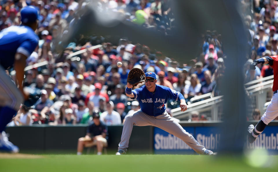 <p>Justin Smoak (14) of the Toronto Blue Jays fields a throw from Josh Donaldson (20) at third base to get Brian Dozier (2) of the Minnesota Twins out at first base as pitcher Marcus Stroman (6) looks on during the first inning of the game on May 22, 2016 at Target Field in Minneapolis, Minnesota. (Hannah Foslien/Getty Images) </p>