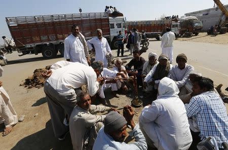 Demonstrators from the Jat community sit on a road as they block the Delhi-Haryana national highway during a protest at Sampla village in Haryana, India, February 22, 2016. REUTERS/Adnan Abidi