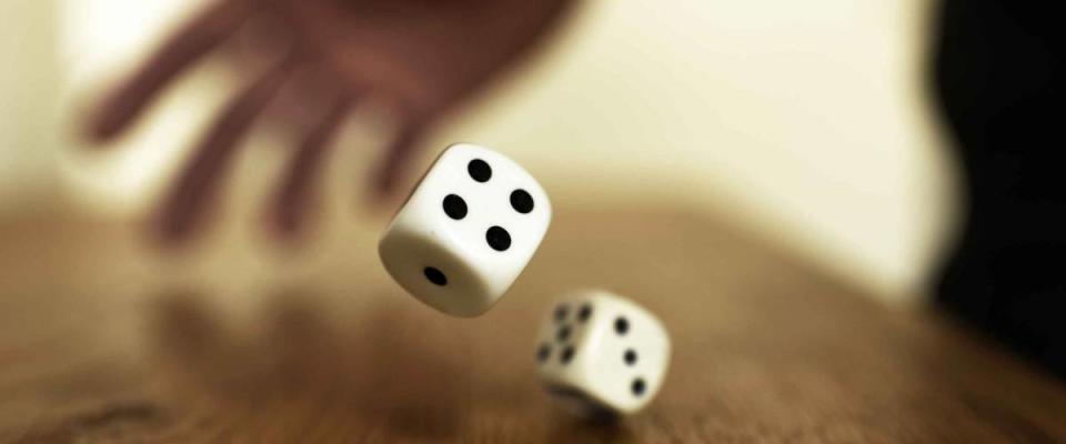 rolling dices on a wooden table