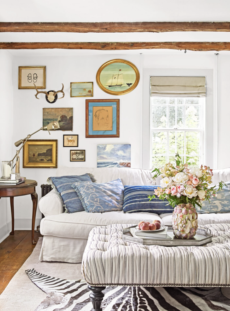 living room with an ivory slipcovered sofa and collected gallery wall