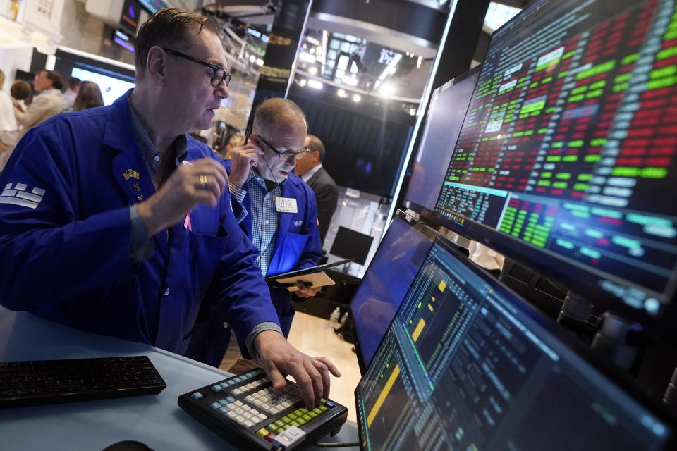 Specialist Patrick King, left, works at his post on the floor of the New York Stock Exchange, Tuesday, Aug. 6, 2024.(AP Photo/Richard Drew)