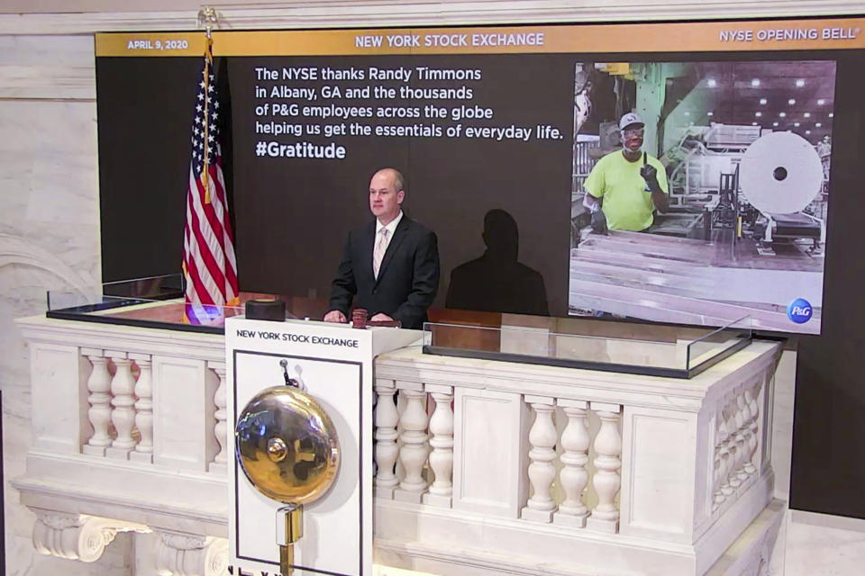 In this photo taken from video provided by the New York Stock Exchange, Chief Security Officer Kevin Fitzgibbons rings the opening bell at the NYSE, while recognizing Randy Timmons in Albany, Ga., and thousands of employees of the Proctor & Gamble Company, Thursday, April 9, 2020. (New York Stock Exchange via AP)