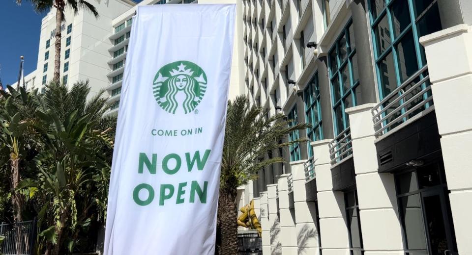 A "Now Open" banner can be seen in front of the new Starbucks coffee shop at the Hilton Daytona Beach Oceanfront Resort on Tuesday, Oct. 10, 2023. The coffee shop is now serving customers. It will hold its grand opening on Oct. 27 when a ribbon-cutting will be held at 10 a.m. with the Daytona Regional Chamber of Commerce. It is on the northeast corner of A1A and Auditorium Boulevard in Daytona Beach.
