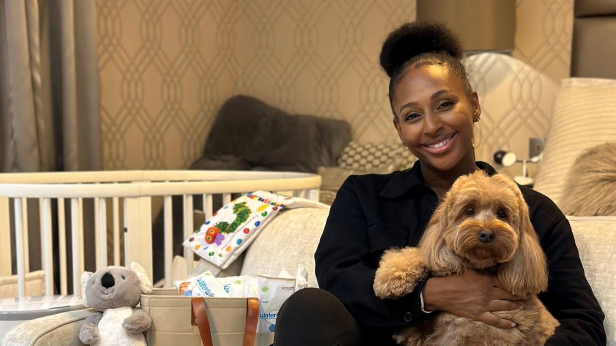 Alexandra Burke sitting in baby nursery