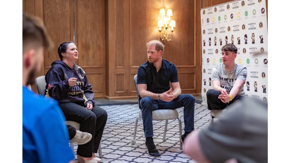 Prince Harry sat in a circle with a group of young people