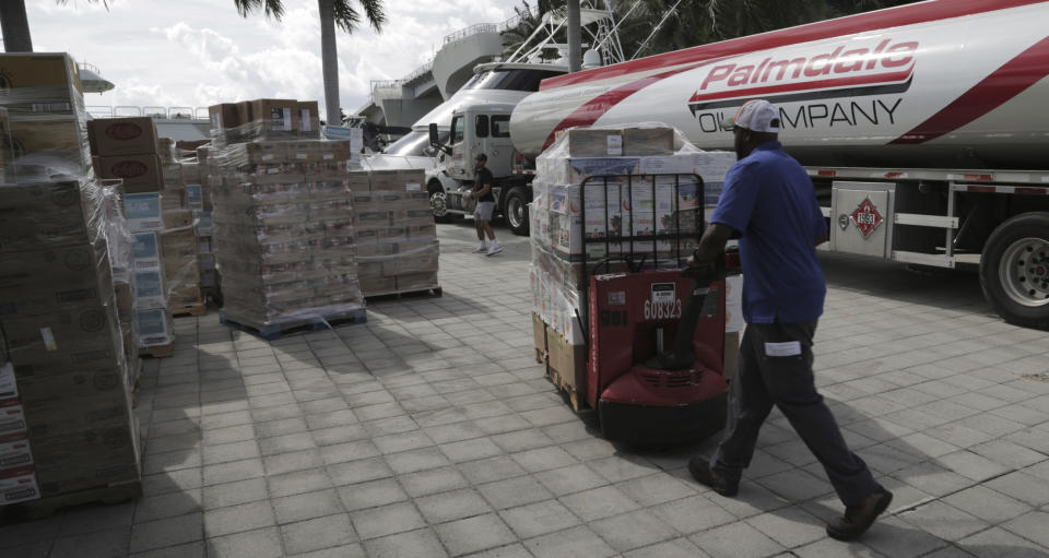 Hurricane relief supplies are ready to be loaded Wednesday, Sept. 4, 2019, in Fort Lauderdale, Fla., on the "Globe" a ship that will make the trek to the Bahamas with much needed help. Chef José Andres' World Central Kitchens is loading up the vessel with the supplies for the victims of Hurricane Dorian that devastated the Bahamas. (Jose A. Iglesias/Miami Herald via AP)