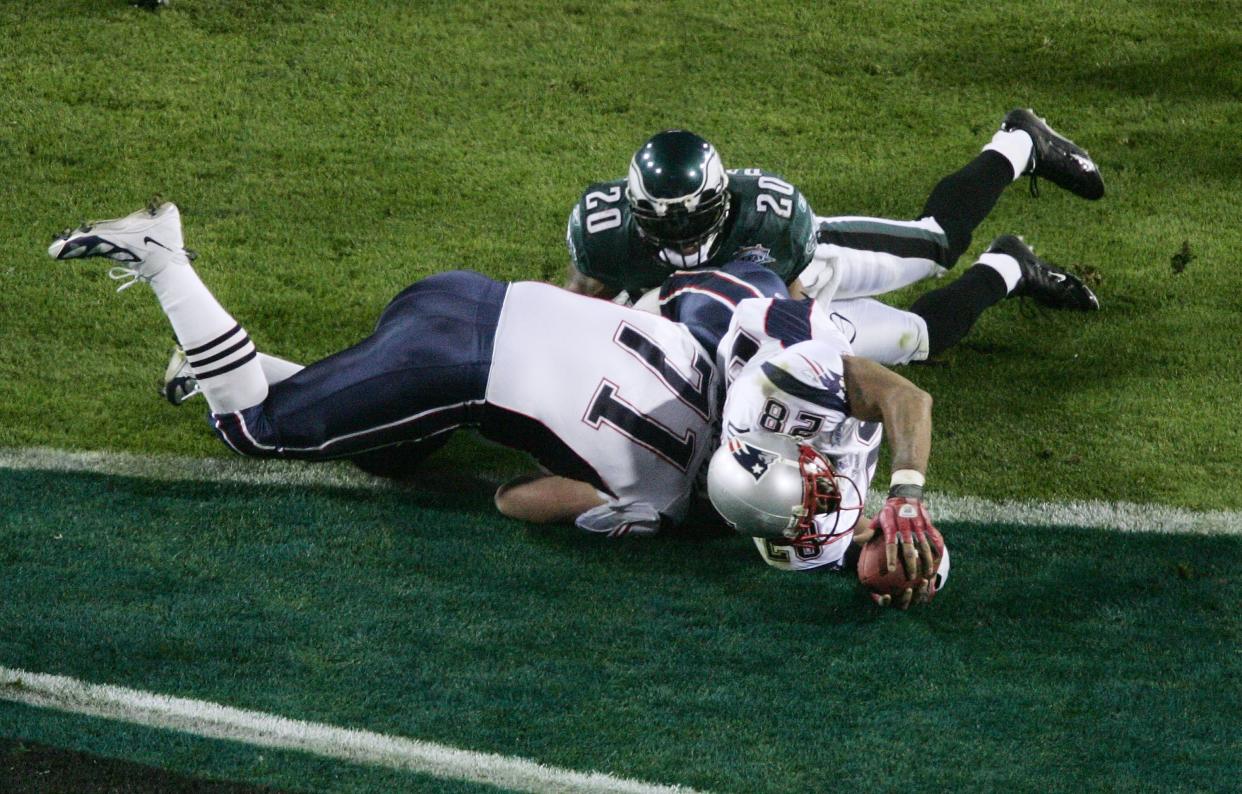 Running back Corey Dillon #28 of the New England Patriots reaches across the goal line to score on a 2-yard touchdown run against the Philadelphia Eagles during the fourth quarter of the Super Bowl XXXIX