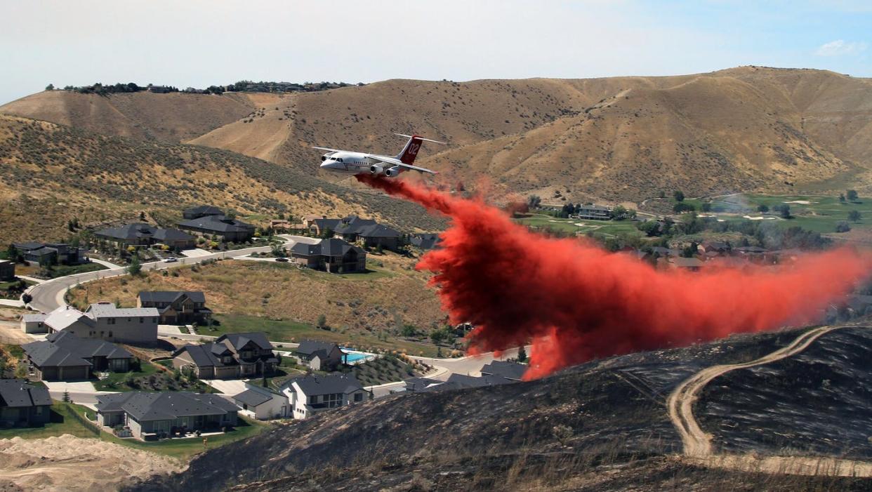 <span class="caption">An airtanker drops retardant to help stop the spread of the 2015 Eyrie Fire in the foothills of Boise, Idaho, which was ignited by sparks from construction equipment. </span> <span class="attribution"><a class="link " href="https://flic.kr/p/NCL5D5" rel="nofollow noopener" target="_blank" data-ylk="slk:Austin Catlin, BLM/Flickr;elm:context_link;itc:0;sec:content-canvas">Austin Catlin, BLM/Flickr</a></span>