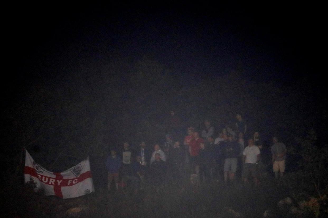 Three Lions supporters took up a viewing spot in the foothills near the stadium: Action Images via Reuters