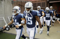 <p>Tennessee Titans wide receiver Eric Weems (14) and wide receiver Darius Jennings (15) walk to the field with arms linked after the national anthem had been played before an NFL football game between the Titans and the Seattle Seahawks Sunday, Sept. 24, 2017, in Nashville, Tenn. Neither team was present on the field for the playing of the anthem. (AP Photo/James Kenney) </p>