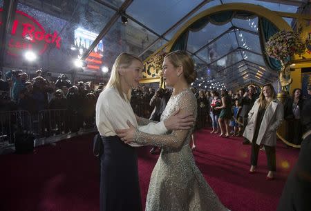 Cast members Cate Blanchett (L) and Lily James greet each other at the premiere of "Cinderella" at El Capitan theatre in Hollywood, California March 1, 2015. The movie opens in the U.S. on March 13. REUTERS/Mario Anzuoni
