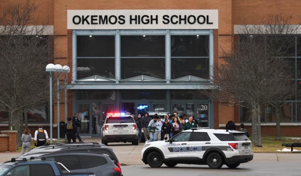 Students evacuate Okemos High School in Meridian Township, Mich., Tuesday morning, Feb. 7, 2023. All students, staff are reported safe after false report of shooting. [AP Photo by MATTHEW DAE SMITH via Lansing State Journal]