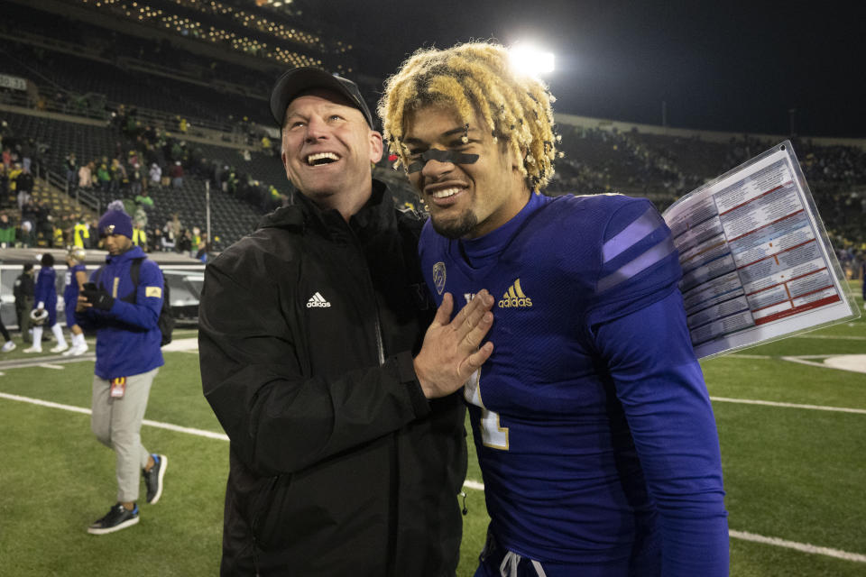 FILE - Washington head coach Kalen DeBoer, front left, celebrates with Washington wide receiver Rome Odunze (1) after they defeated Oregon in an NCAA college football game Saturday, Nov. 12, 2022, in Eugene, Ore. DeBoer earned AP All-Pac-12 coach of the year honors on Thursday, Dec. 8. (AP Photo/Andy Nelson, File)