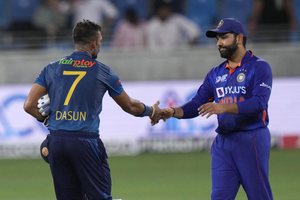 India's captain Rohit Sharma, right, shake hands with Sri Lanka's captain Dasun Shanaka to congratulate him after Sri Lanka won the T20 cricket match of Asia Cup, in Dubai, United Arab Emirates, Tuesday, Sept. 6, 2022. (AP Photo/Anjum Naveed)