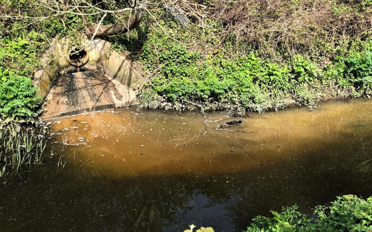 A discharge outlet oozing waste into a river in Somerset