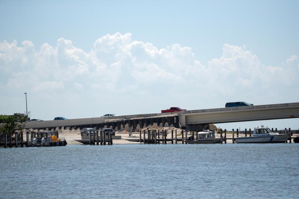 Contractors for the Florida Department of Transportation continue their work on the Sanibel Causeway on Thursday, Sept 7, 2023. Crews are paving new lanes as cranes so they can raise the existing roadway and backhoes are working in other areas to restore and improve the roadway.