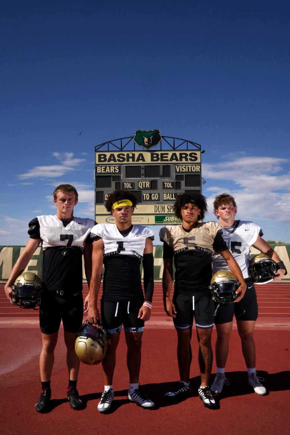 Basha players (left to right) Tommy Prassas, Miles Lockhart, Demond Williams Jr. and Jack Bleier at their school's home football field in Chandler on Aug. 14, 2023.