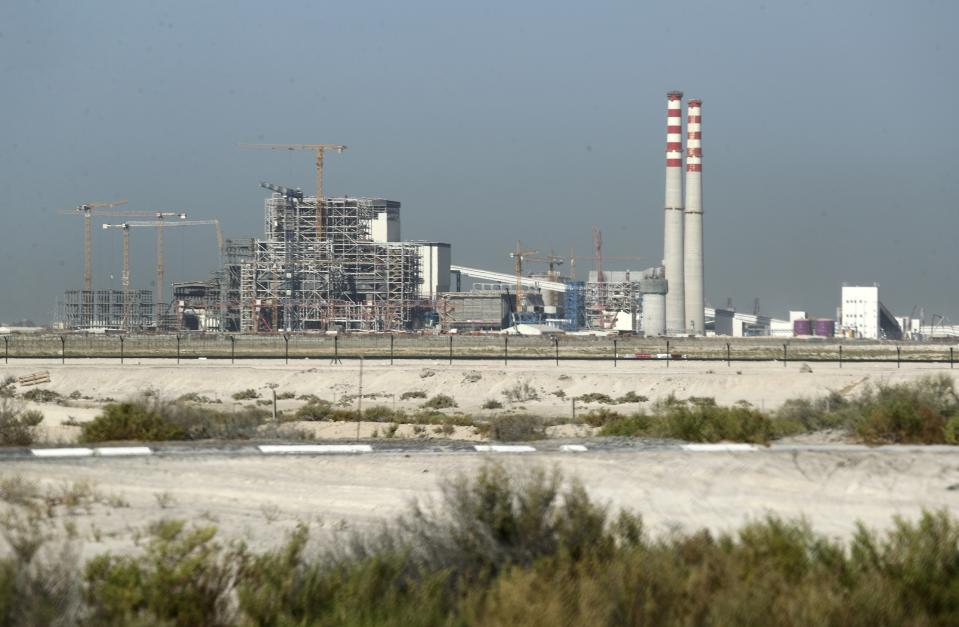 The coal-powered Hassyan power plant is under construction in Dubai, United Arab Emirates, Wednesday, Oct. 14, 2020. In the oil-rich UAE, an unusual sight is rising in Dubai -- a coal-fired power plant, a first for the region. The $3.4 billion Hassyan power plant in Dubai appears puzzling as the UAE hosts the headquarters of the International Renewable Energy Agency. (AP Photo/Kamran Jebreili)